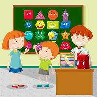 Students learning shapes in classroom vector