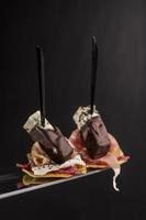 Isolated canape with bacon and blue cheese is covered chocolate photo