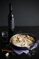 Clafoutis with pears and red dessert wine photo