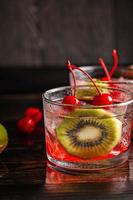 Cold summer cocktail drink with cherry and kiwi