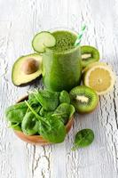 Green fresh healthy detox smoothie with spinach, avocado, kiwi. photo