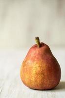 Single Pear on White Wood Table