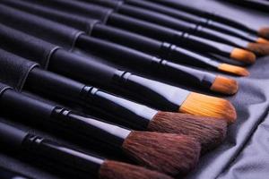 Set of black make-up brushes in row photo