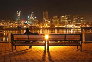 Person Sitting on a Bench Overlooking Downtown photo