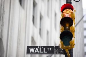 Wall street and red traffic  light photo