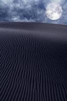 Desert dunes sand in moon night sky