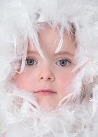Little girl with white feathers