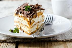 Sponge cake with cream and chocolate photo