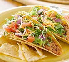 beef tacos with lettuce and other toppings