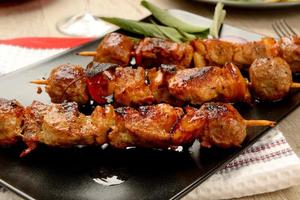 Skewers of meat cooked ready to eat photo