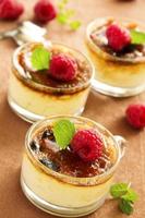 Creme brulee with raspberries and mint. photo