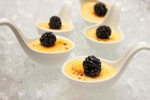 creme brulee desserts topped with fresh berries.