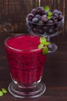 Frozen black currant berries smoothie with mint photo