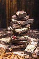 stack of chocolate on a wooden background photo