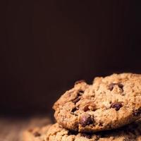 Chocolate chip cookies on wooden background. Stacked photo
