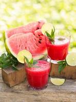 Two glasses of watermelon smoothies with lime and mint photo