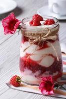 Milk dessert with fresh raspberries closeup and flowers photo