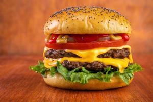 Double cheeseburger on red table with red background photo