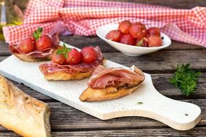 Italian ham dry cured prosciutto on bread toast photo