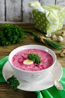 Cold beet soup with egg, cucumber, potatoes and greens photo