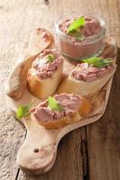 healthy chicken liver pate with sage in jar and bread photo
