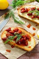 Bruschetta with red haricot bean, tomato sauce and dill photo