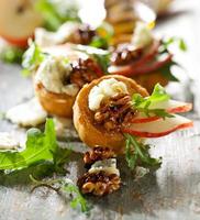 Canapes with pear, walnuts, blue cheese and arugula