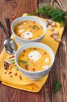 Pumpkin soup with peanuts on a wooden table