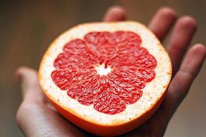 Grapefruit in hand photo