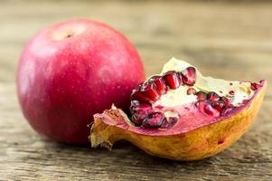 Pomegranate isolated on wooden background