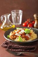 italian pasta spaghetti bolognese with basil on rustic table photo