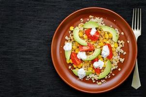 salad with quinoa, red lentils, corn, avocado and tomato