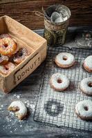 Tasting sweet donuts with icing sugar