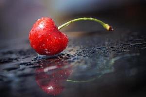 Splashing cherry, reflection surface, minimalism