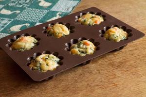 Muffin with salmon, spinach and cheese in silicone bakeware