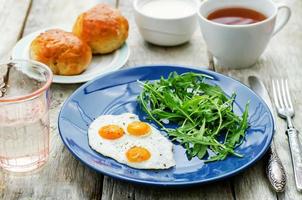fresh breakfast with scrambled eggs and arugula