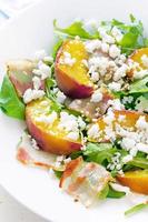 salad with peaches, bacon; arugula, spinach and goat cheese photo