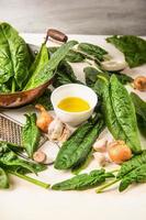 Fresh spinach cooking, preparation with pan,oil, garlic and nutmeg