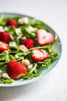 Salad with arugula,strawberries and cheese photo