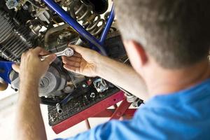 Mechanic Using Ratchet for Engine Repair photo