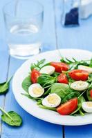 salad with arugula, spinach, tomatoes and eggs.