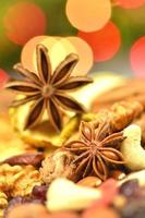 christmas spices, nuts, cookies and dried fruits on bokeh background