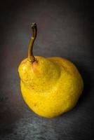 One pear on black background photo