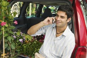 Man Using Cell Phone at Plant Nursery