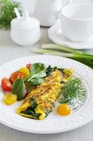 Omelet with spinach and lettuce tomato. photo