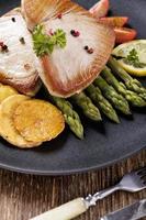 Grilled tuna steak served on asparagus with roasted zmieniakami photo
