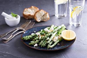 Warm salad with asparagus, feta cheese and lemon photo