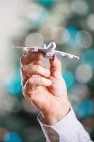 Closeup of man hand holding model of airplane photo