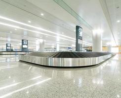 Single suitcase alone on airport carousel photo