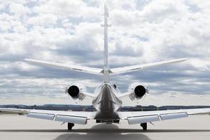 Aircraft learjet Plane in front of Airport with cloudy sky photo